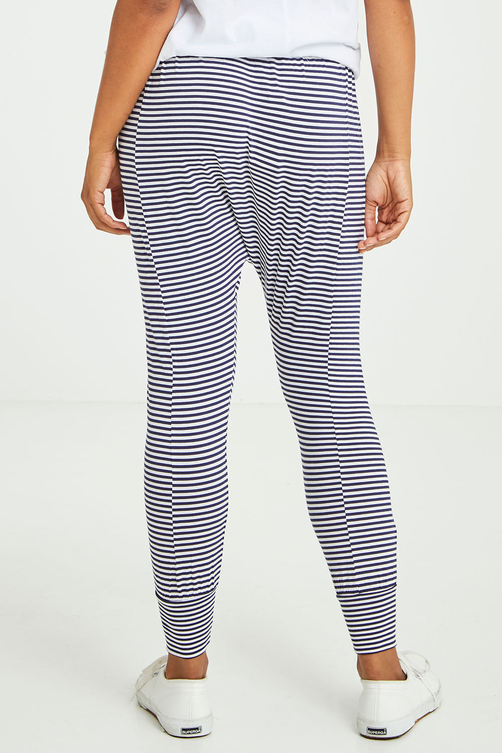 Model Olivia wearing size 10 of the Barcelona Pant in colour Navystripe (Blue), from the back