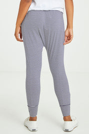 Model Olivia wearing size 10 of the Barcelona Pant in colour Navystripe (Blue), from the back