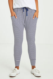 Model Olivia wearing size 10 of the Barcelona Pant in colour Navystripe (Blue), from the front, cropped image