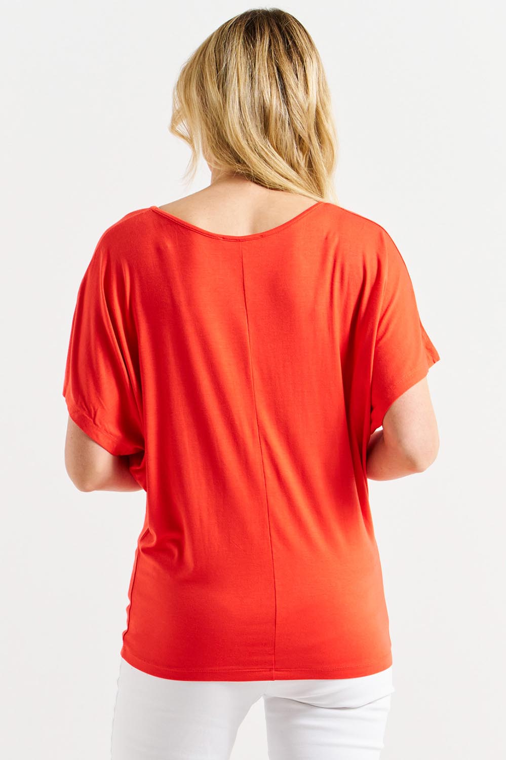 A model wearing the Maui Tee in colour Flamered (Red), from the back