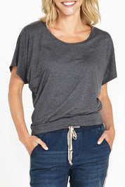 A model wearing the Maui Tee in colour Charcoal (Grey), from the front, cropped image