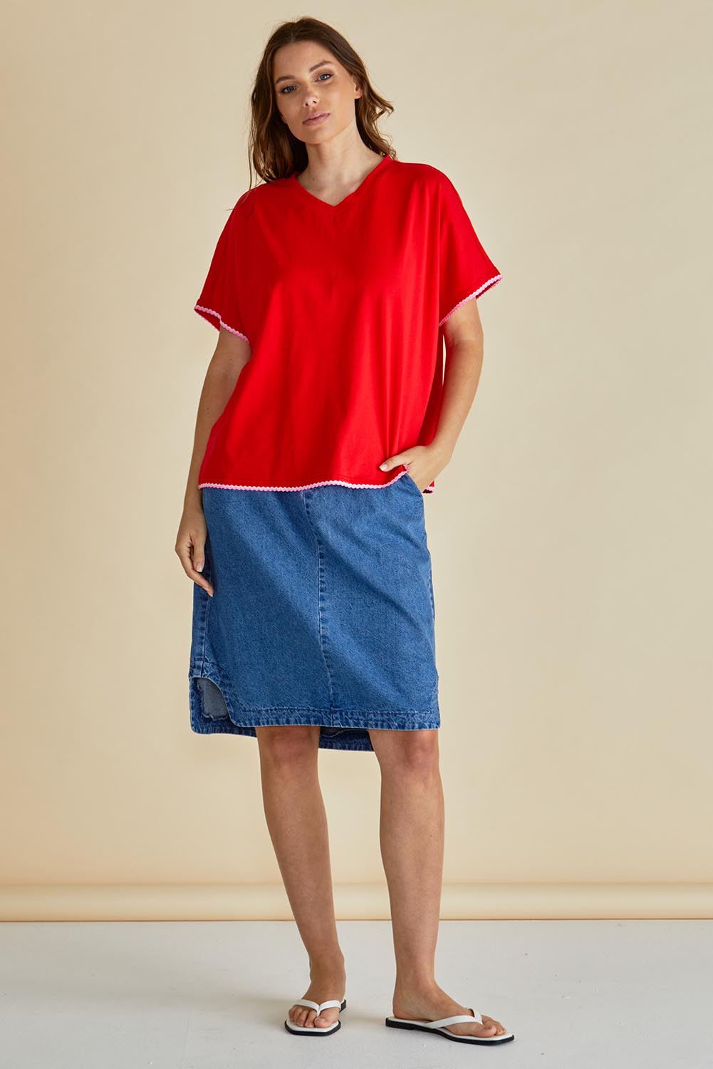 A model wearing the Avalon Cotton Tee in colour Red (Red), from the front, showing the whole outfit