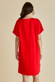 A model wearing the Stellar Cotton Tin colourShirt Dress - Red (Red), from the back