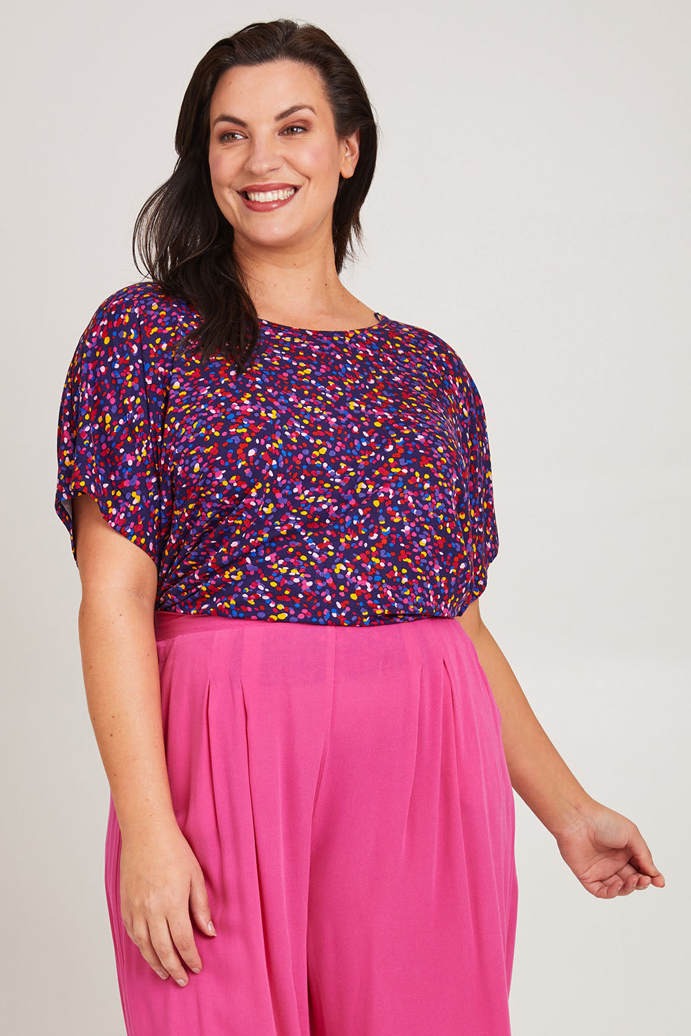 Model Poppy wearing size 16 of the Maui Tee in colour Confetti (Blue), from the front, cropped image