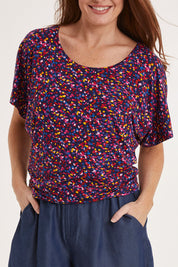 Model Sally wearing size 10 of the Maui Tee in colour Confetti (Blue), from the front, cropped image