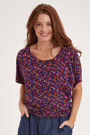 Model Sally wearing size 10 of the Maui Tee in colour Confetti (Blue), from the front, cropped image