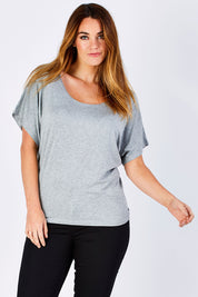 Model Laura wearing size 12 of the Maui Stretch Tee in colour SilverMarl (Grey), from the front, cropped image