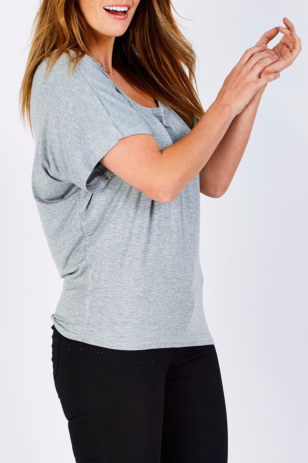 Model Laura wearing size 12 of the Maui Stretch Tee in colour SilverMarl (Grey), from the front, cropped image