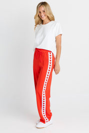 Model Genericm wearing size sample of the Jamie Track Pant – Tomato in colour Tomato, from the front