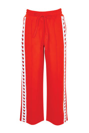 Product shot of the Jamie Track Pant – Tomato in colour Tomato, from the front