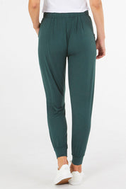 A model wearing the Paris Pant in colour Ivy (Green), from the back