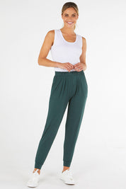 A model wearing the Paris Pant in colour Ivy (Green), from the front, showing the whole outfit
