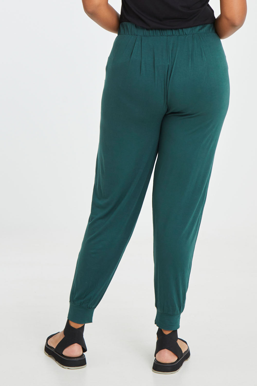 Model Noli wearing size 14 of the Paris Pant in colour Ivy (Green), from the back