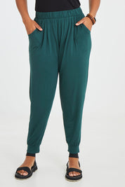 Model Noli wearing size 14 of the Paris Pant in colour Ivy (Green), from the front, cropped image