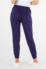 A model wearing the Paris Pant in colour Navy (Blue), from the back