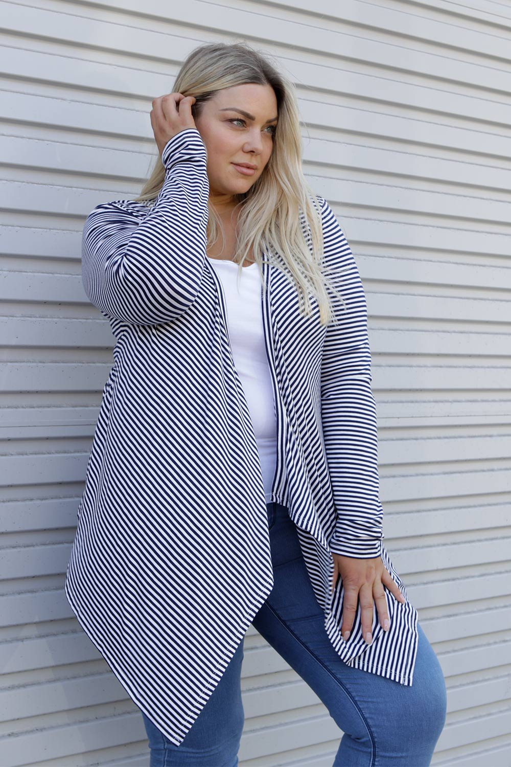 A model wearing the Melbourne Stretch Cardigan in colour NavyWhtStr (Blue), from the front, showing the whole outfit