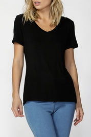 A model wearing the Manhattan Stretch Tee in colour Black (Black), from the front, cropped image