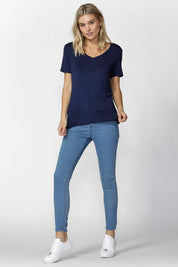 A model wearing the Manhattan Stretch Tee in colour Navy (Blue), from the front, showing the whole outfit