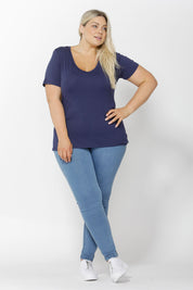 A model wearing the Manhattan Stretch Tee in colour Navy (Blue), from the front, showing the whole outfit