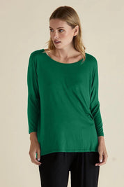 A model wearing the Milan 3/4 Sleeve Top in colour Emerald (Green), from the front, cropped image