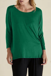 A model wearing the Milan 3/4 Sleeve Top in colour Emerald (Green), from the front, cropped image