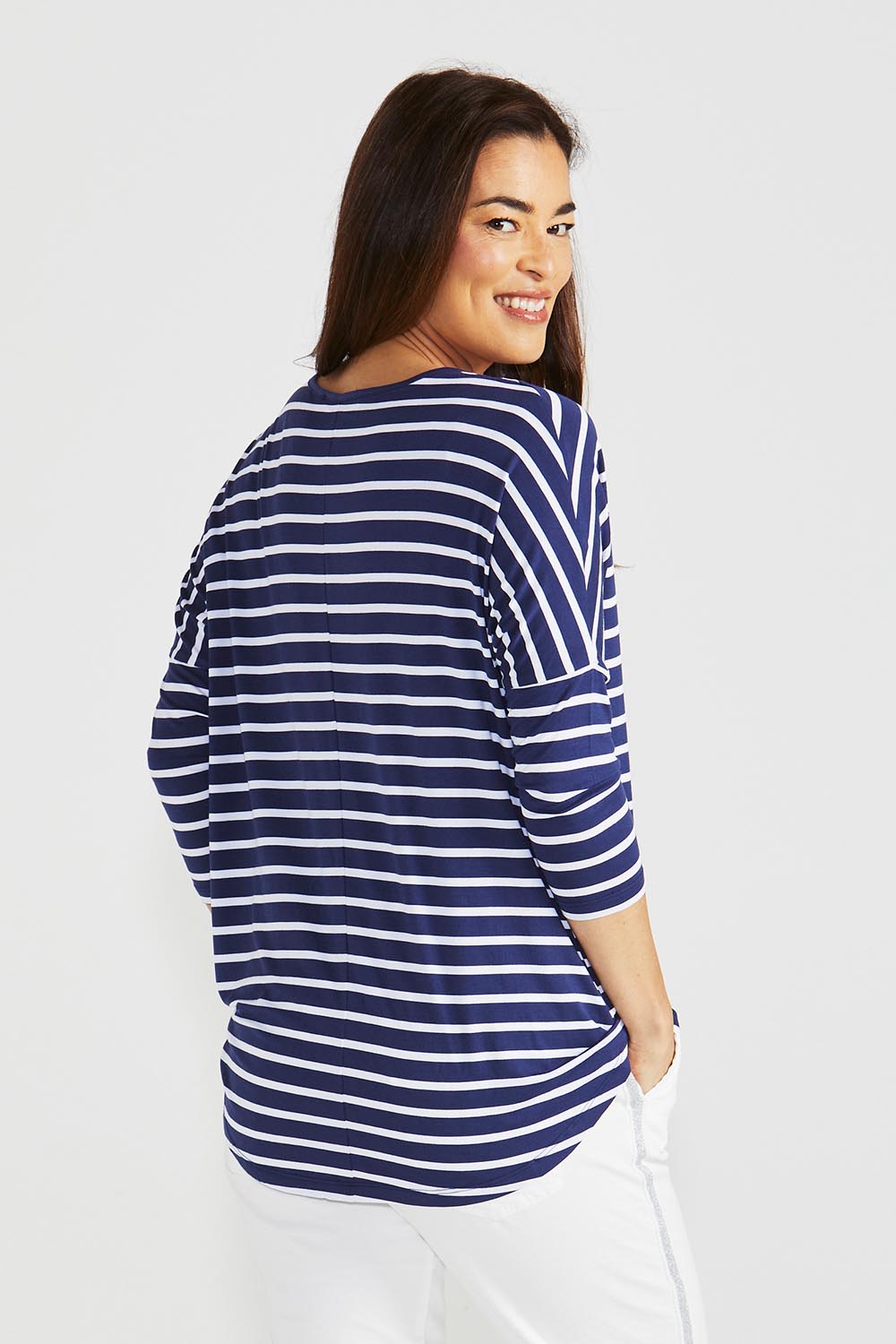 A model wearing the Milan 3/4 Sleeve Top in colour Paristripe (Blue), from the back