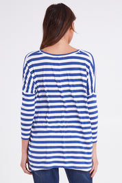 Model Madeline wearing size 10 of the Geneva Tee in colour Whitestrip (White), from the back