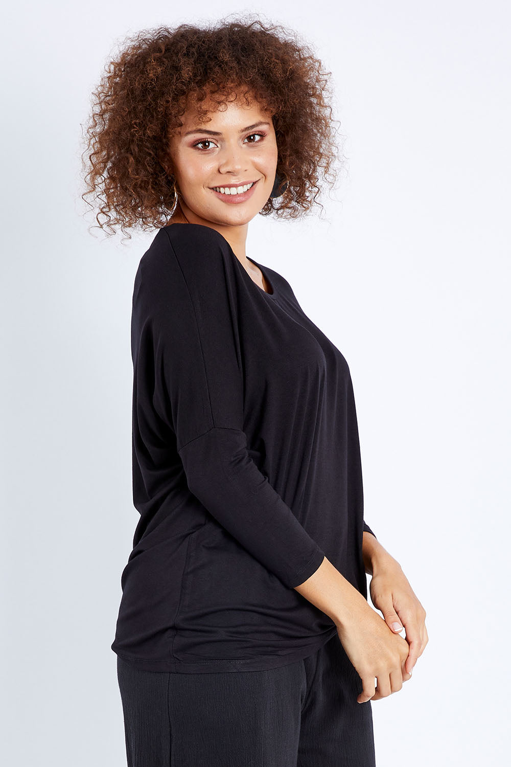 Model Lala wearing size 10 of the Atlanta Top in colour Black (Black), from the front, cropped image