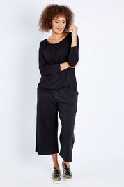Model Lala wearing size 10 of the Atlanta Top in colour Black (Black), from the front, showing the whole outfit