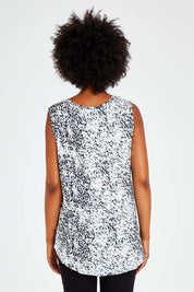 Model Olivia wearing size 10 of the Capri Tank in colour Spotty (White), from the back
