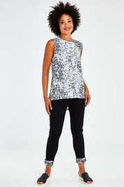 Model Olivia wearing size 10 of the Capri Tank in colour Spotty (White), from the front, showing the whole outfit