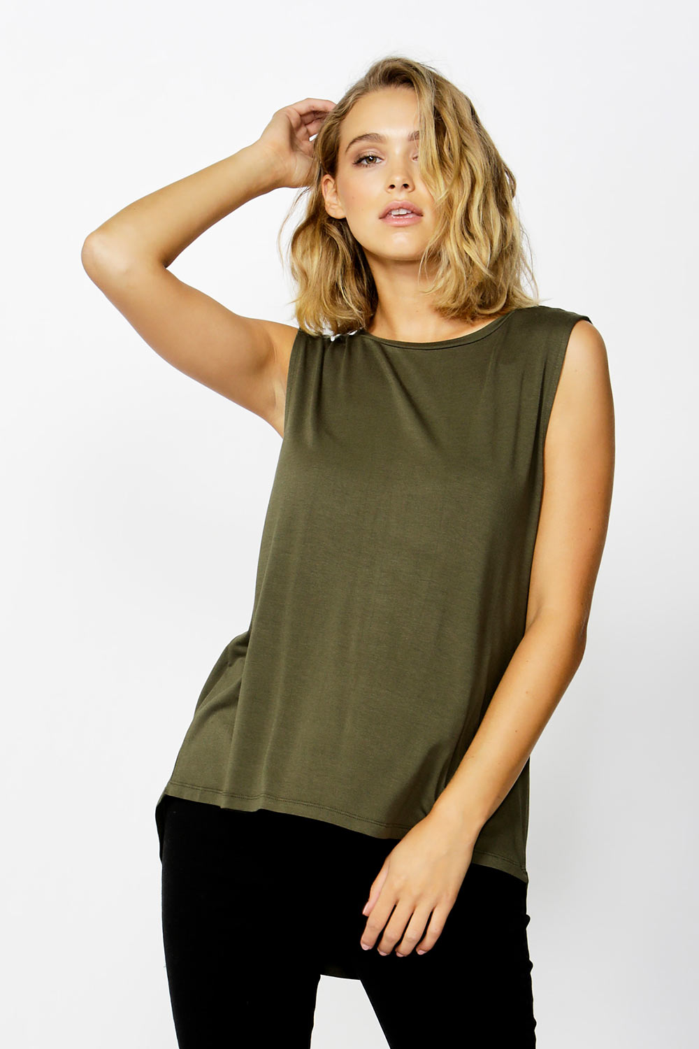 A model wearing the Capri Tank in colour Olive (Green), from the front, cropped image