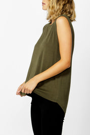 A model wearing the Capri Tank in colour Olive (Green), from the front, cropped image