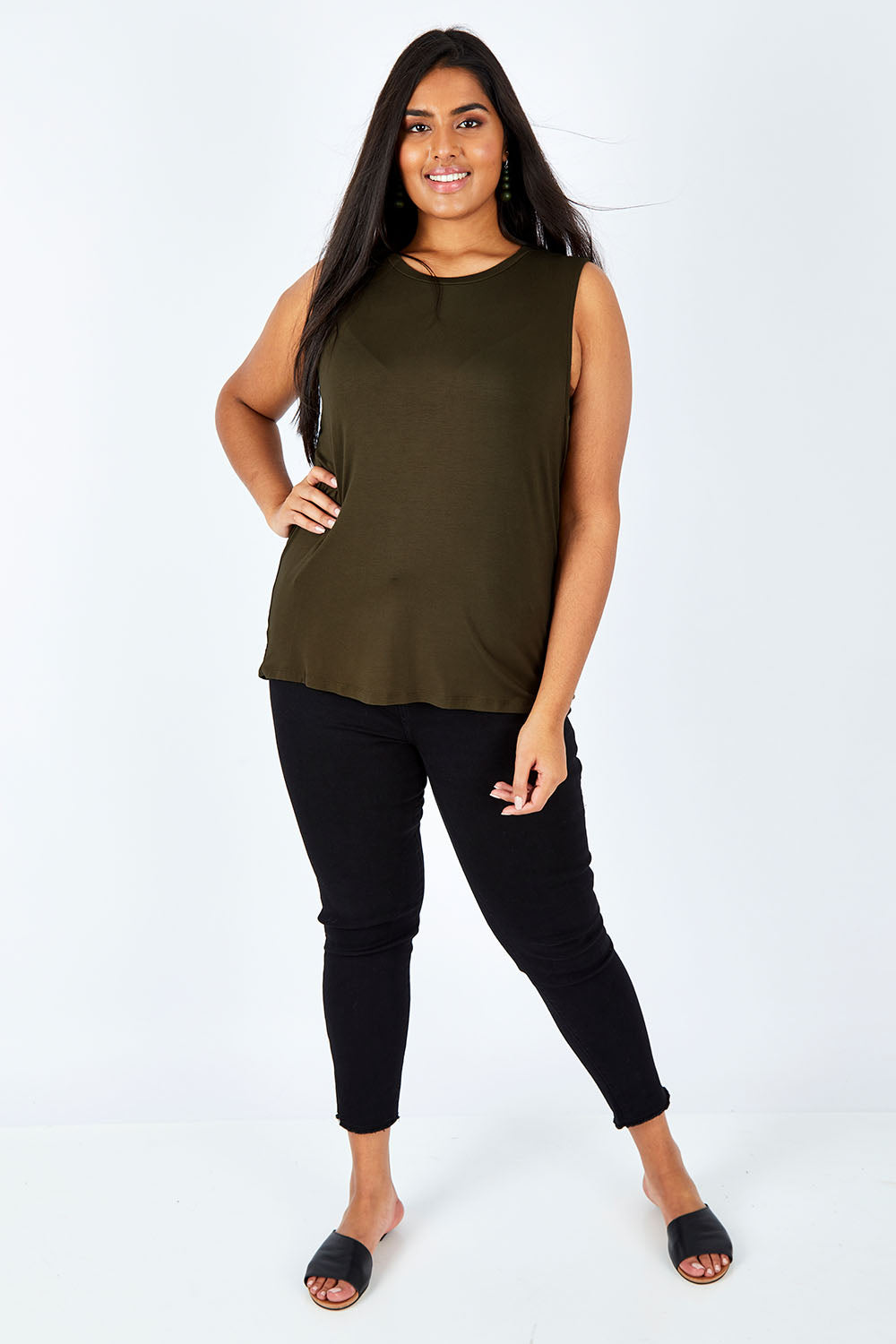 Model Shanaya wearing size 14 of the Capri Tank in colour Olive (Green), from the front, showing the whole outfit