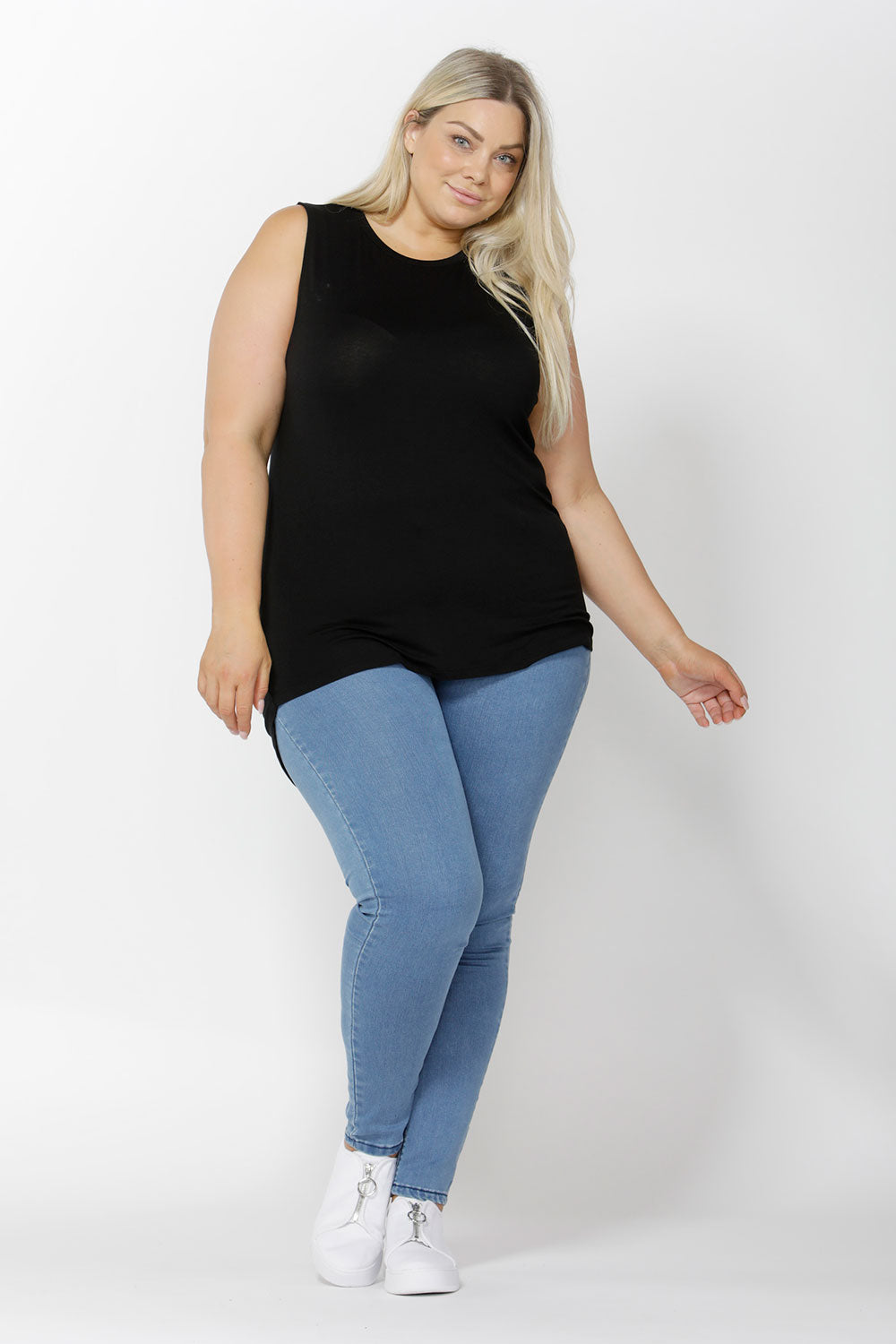 A model wearing the Capri Tank in colour Black (Black), from the front, showing the whole outfit