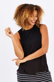 Model Summer wearing size 10 of the Capri Tank in colour Black (Black), from the front, cropped image