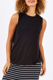 Model Summer wearing size 10 of the Capri Tank in colour Black (Black), from the front, cropped image