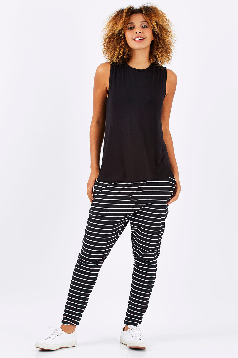 Model Summer wearing size 10 of the Capri Tank in colour Black (Black), from the front, showing the whole outfit