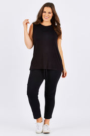 Model Tia wearing size 14 of the Capri Tank in colour Black (Black), from the front, showing the whole outfit