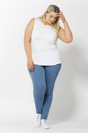 A model wearing the Capri Tank in colour White (White), from the front, showing the whole outfit