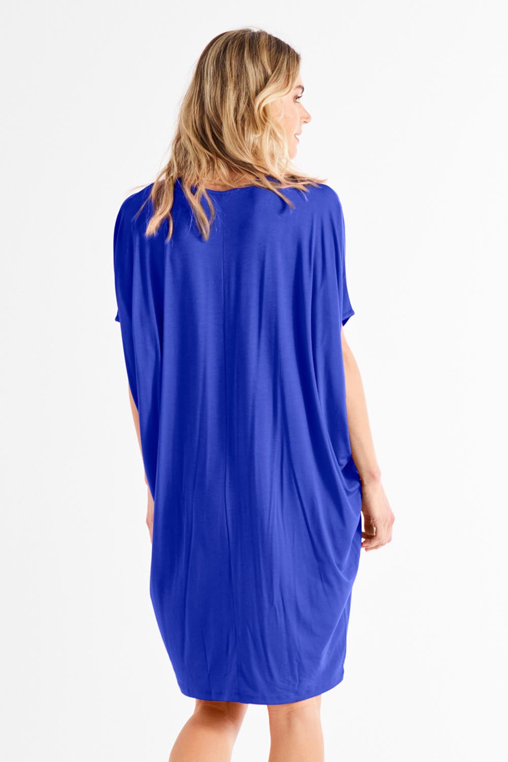 A model wearing the Maui Dress in colour Vividblue (Blue), from the front, showing the whole outfit