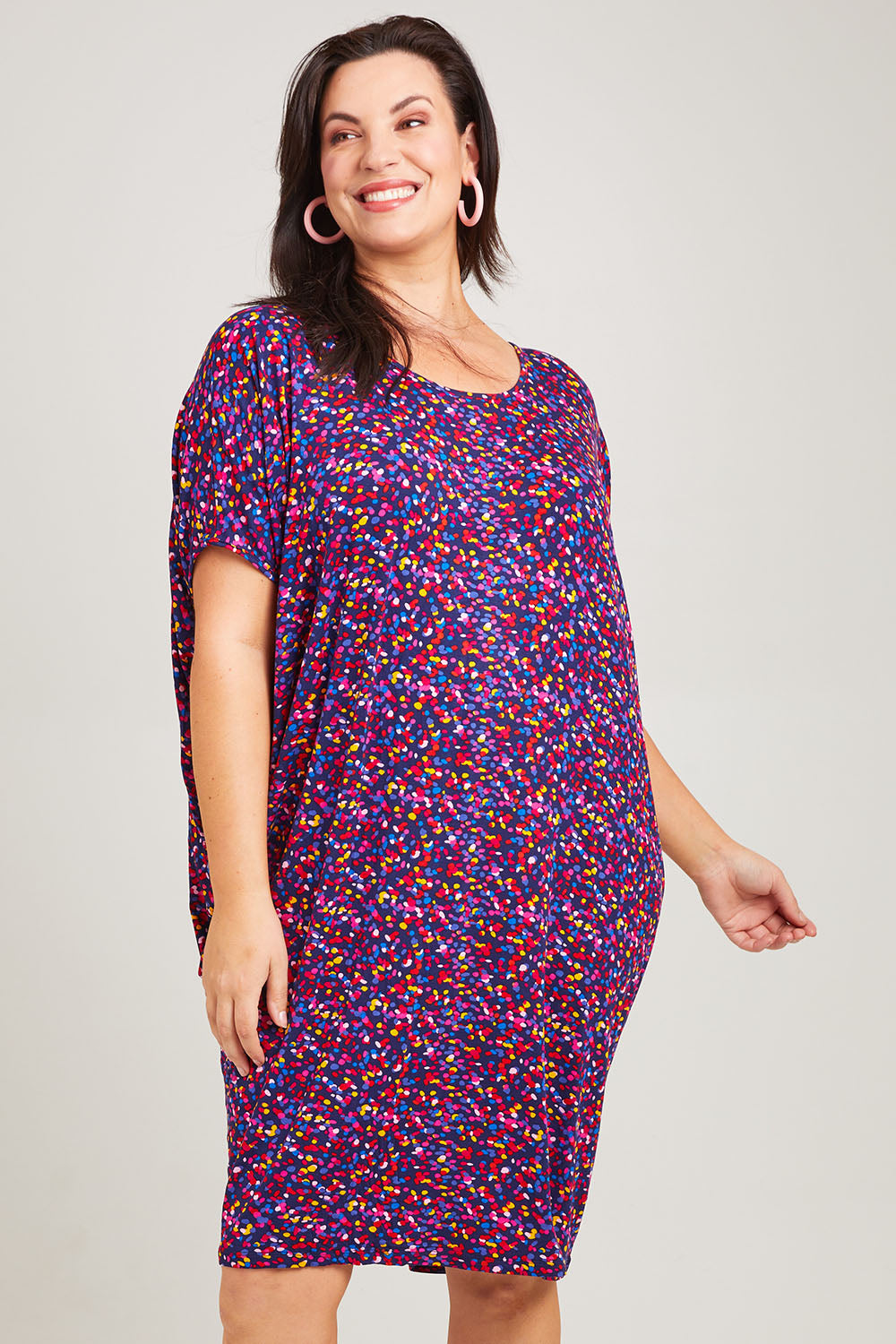 Model Poppy wearing size 16 of the Maui Dress in colour Confetti (Blue), from the front, cropped image