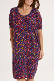 Model Sally wearing size 10 of the Maui Dress in colour Confetti (Blue), from the front, cropped image