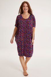 Model Sally wearing size 10 of the Maui Dress in colour Confetti (Blue), from the front, showing the whole outfit