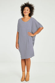 Model Olivia wearing size 10 of the Maui Dress in colour Navywhite (Blue), from the front, showing the whole outfit