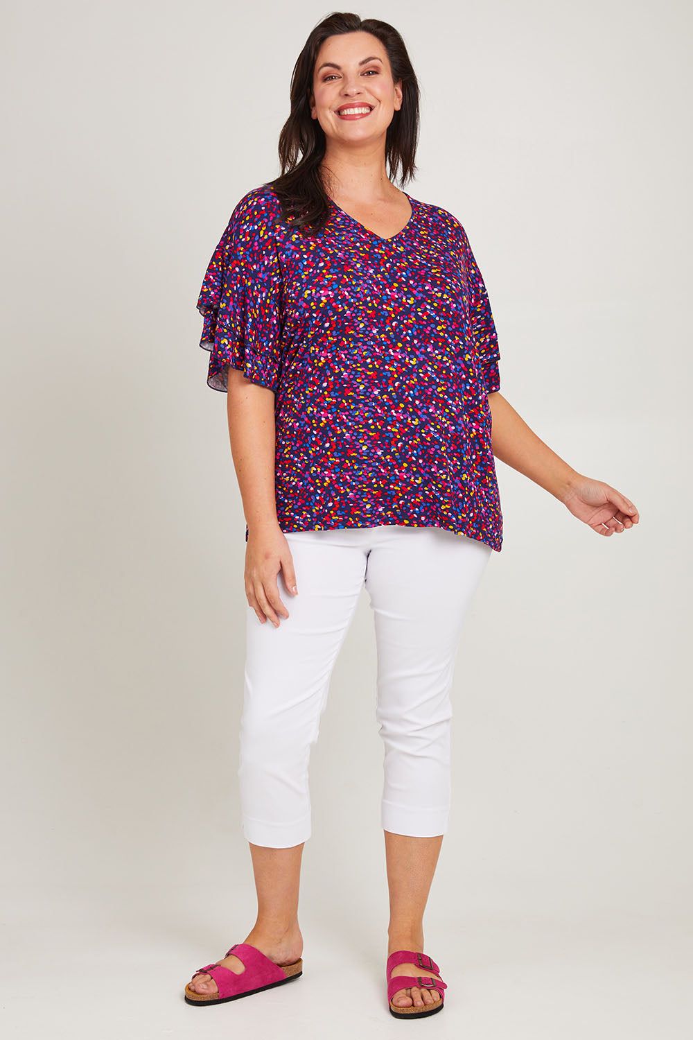 Model Poppy wearing size 16 of the Ripon Top in colour Confetti (Blue), from the front, showing the whole outfit