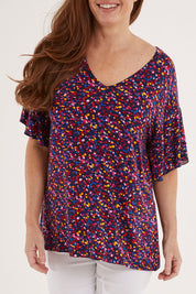 Model Sally wearing size 10 of the Ripon Top in colour Confetti (Blue), from the front, cropped image