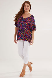 Model Sally wearing size 10 of the Ripon Top in colour Confetti (Blue), from the front, showing the whole outfit
