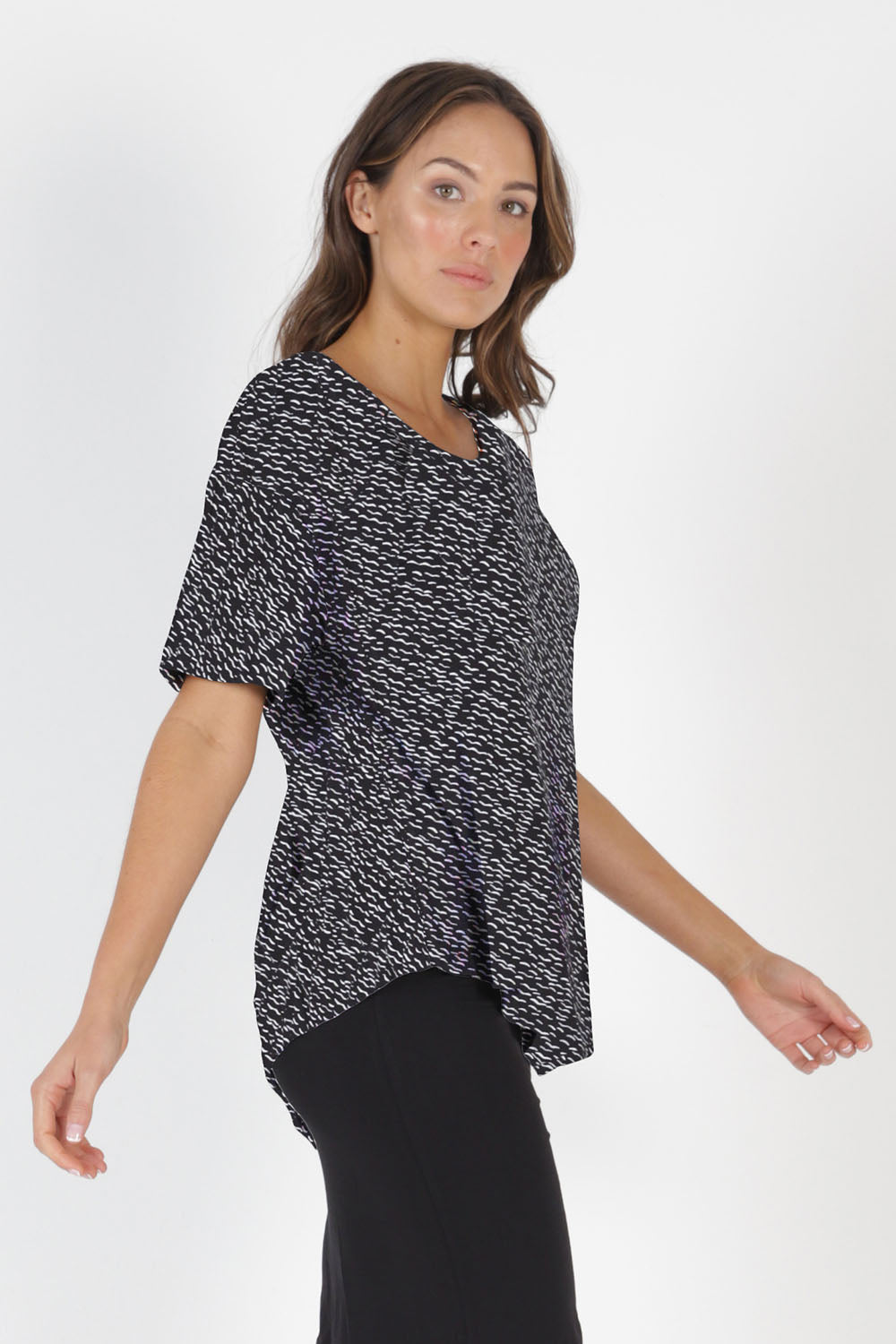 Model Madeline wearing size 10 of the Sicily Top in colour Geo (Black), from the front, cropped image