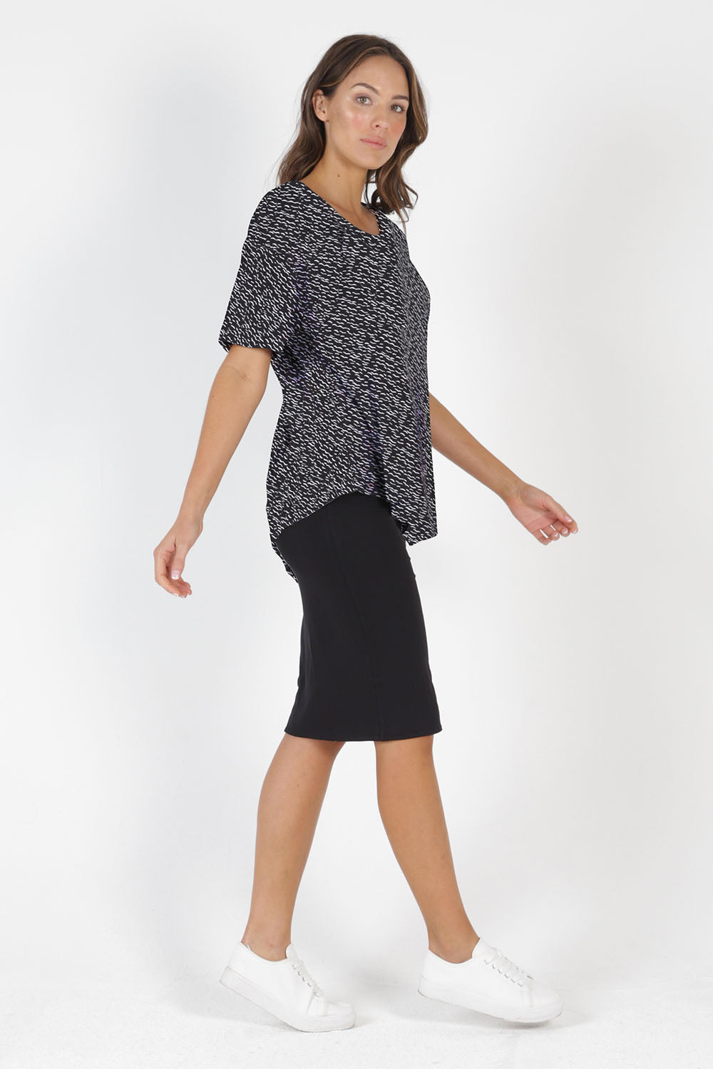 Model Madeline wearing size 10 of the Sicily Top in colour Geo (Black), from the front, showing the whole outfit